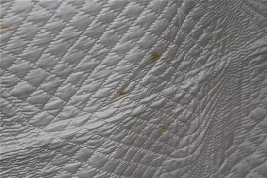 An off-white quilt with blue stitching, a reversible blue and cream quilt, a creamy oyster quilt and a mint green quilt (4)